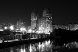 Fototapeta  - Lights night city with reflections on the river black and white