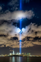 Fototapete - September 11 commemoration with the Tribute in Light, New York City. Two columns of light illuminate the sky over Lower Manhattan near the One World Trade Center skyscraper