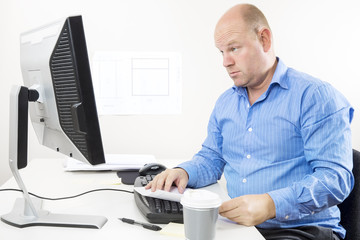 Wall Mural - Businessman looking questioning at the computer screen