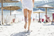 Woman in white running on beach