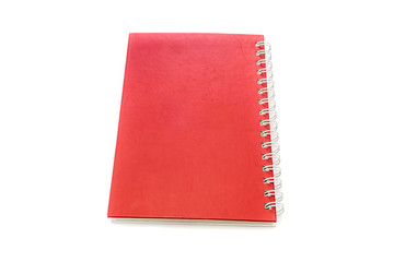 Wall Mural - Red notebook isolated on white background.