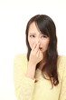Japanese woman holding her nose because of a bad smell