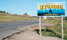 Highway Sign Indicating The Border Of Wyoming, Looking East From South Dakota On Highway 24 (Wyoming)/Highway 34 (South Dakota)