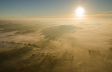  Sunrise over the misty fall landscape from the air