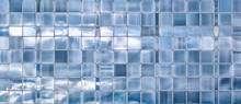 Wall Of Windows Reflecting Shimmering Blue Sky And Clouds. Abstract Background