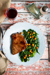 Wall Mural - Fresh steak with green salad on rustic wooden background