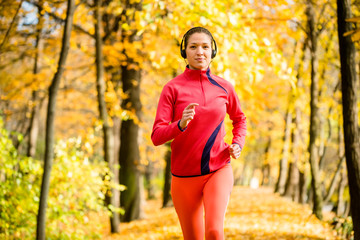 Wall Mural - Woman jogging and listening music