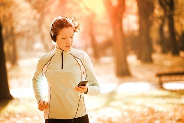 Wall Mural - Woman jogging and listening music