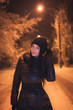 girl on the street at night in winter jackets
