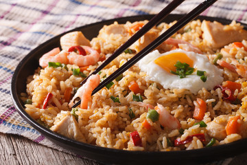 Wall Mural - Fried rice nasi goreng with chicken and shrimp close-up horizontal
