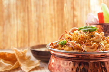 Vegetable Biryani, Indian cuisine accompanied with fresh slice of carrot, cucumber, onion, papad and Raita garnished with fried beans,onion and cashew nuts