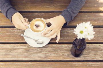 Wall Mural - Girl with cappuccino and flowers outside