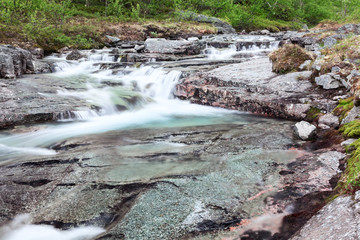 Wall Mural - Mountain beautiful waterfall cascades with flowing clear water from the tops