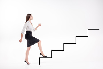 Young businesswoman walking up on stairs