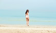 © Syda Productions - young woman in swimsuit walking on beach