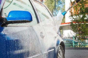 Wall Mural - Blue car in a car wash