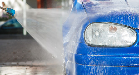 Wall Mural - Blue car in a car wash