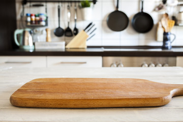 Empty wooden cutting board and blurred kitchen background, product display