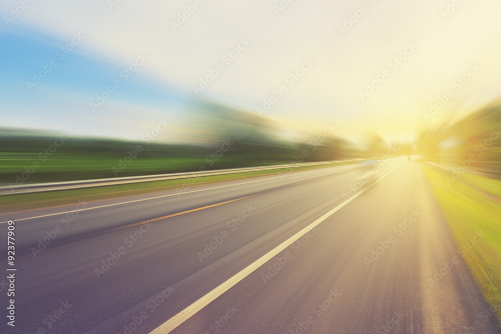 Empty asphalt road in motion blur and sunlight with vintage tone - obrazy, fototapety, plakaty 