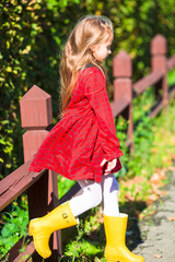 Wall Mural - Adorable little girl outdoors at beautiful autumn day