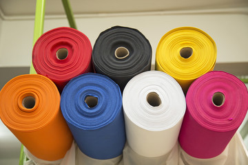 Colorful material fabric rolls in warehouse