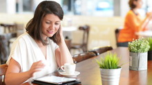 Beautiful woman at bar serving breakfast using digital tablet