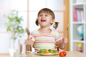 happy little girl with healthy food for dinner