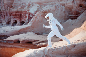 Wall Mural - futuristic astronaut on another planet, image with the effect of