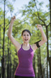 © PR Image Factory - Sporty asian woman with arms up celebrating success