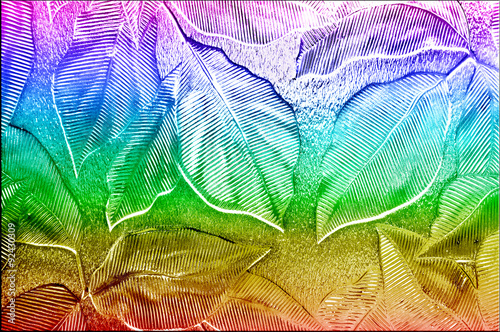 Fototapeta na wymiar Glass with embossed leaf pattern and rainbow colours