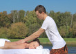 © PaulShlykov - Man giving massage to young brunette outdoors