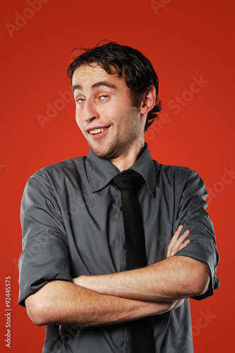 Fotografie, Obraz Expressive comic conceited young man isolated on red background