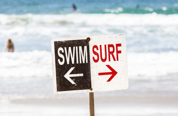 Swim and surf sign on the beach, California, USA.