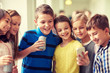 © Syda Productions - group of school kids with smartphone and soda cans