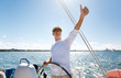 © Syda Productions - senior man at helm on boat or yacht sailing in sea