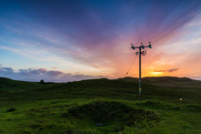 Telephone Or Electricity Line In The Fields At Sunset