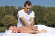 © PaulShlykov - Man giving massage to young brunette outdoors