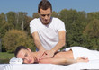 © PaulShlykov - Man giving massage to young brunette outdoors