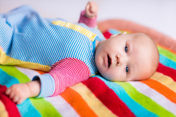 Wall Mural - cute baby on a colorful blanket