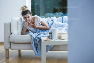 Wall Mural - Sick woman on the sofa