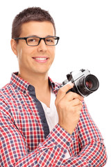 Canvas Print - Young male photographer holding a camera