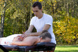 © PaulShlykov - Man giving massage to young brunette outdoors