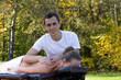 © PaulShlykov - Man giving massage to young brunette outdoors