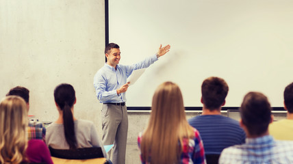 Wall Mural - group of students and smiling teacher with notepad