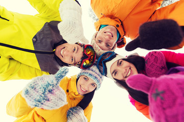 Canvas Print - happy friends in winter clothes outdoors