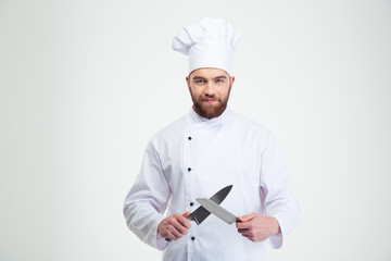 Wall Mural - Happy male chef cook sharpening knife