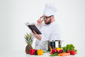 Poster - Chef cook in glasses reading recipe book