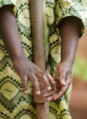 Wall Mural - Young African school boy holding hands under a tap. Water scarcity problems concern the inadequate access to safe drinking water. 1 billion people in the developing world don't have access to it.