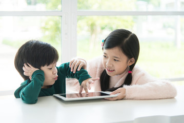 Wall Mural - Cute asian children using tablet