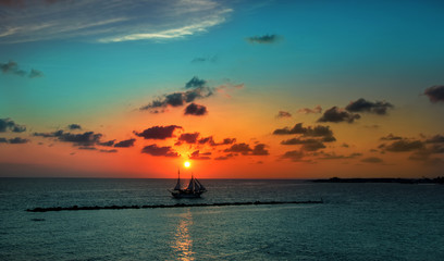 Wall Mural - sailboat against a background of picturesque sunset